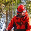 Metsätyöntekijä suojavarusteissa Kainuun syysmetsässä – työaikalaki koskee myös ulkotyötä.